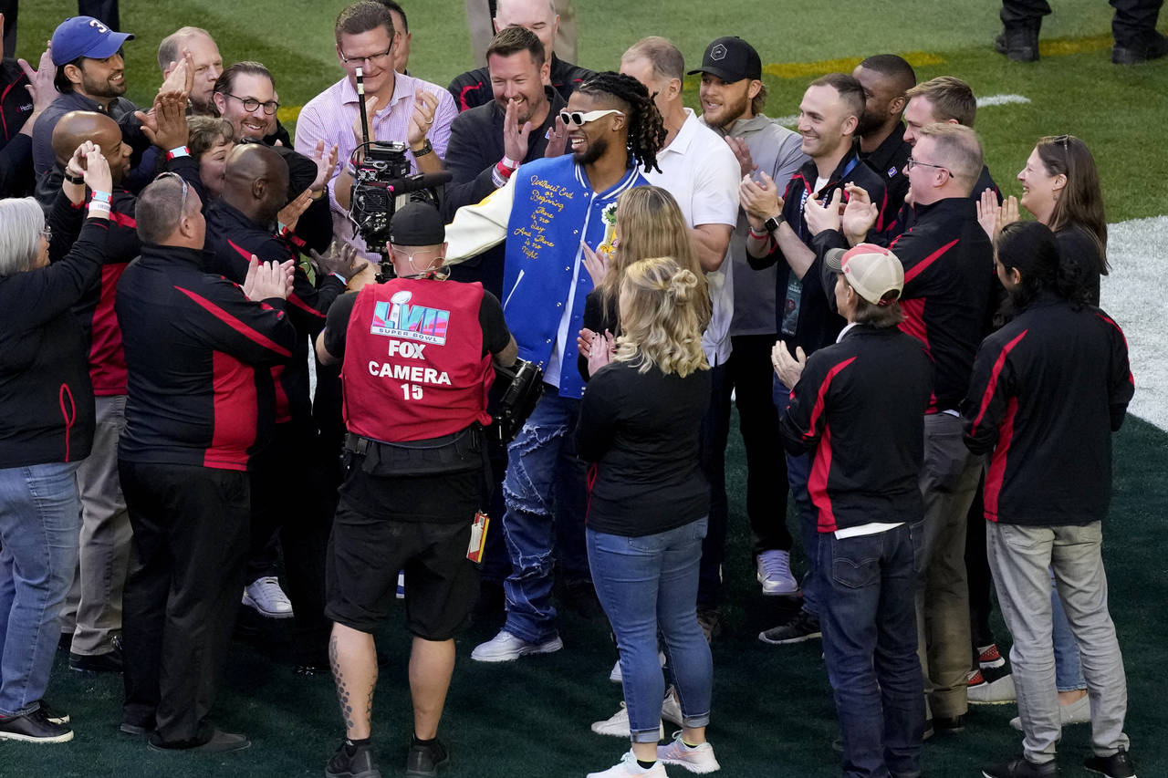 Buffalo Bills' Damar Hamlin, center, is surrounded on the field prior to the NFL Super Bowl 57 foot...