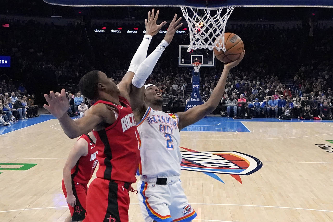 Oklahoma City Thunder guard Shai Gilgeous-Alexander (2) shoots in front of Houston Rockets forward ...