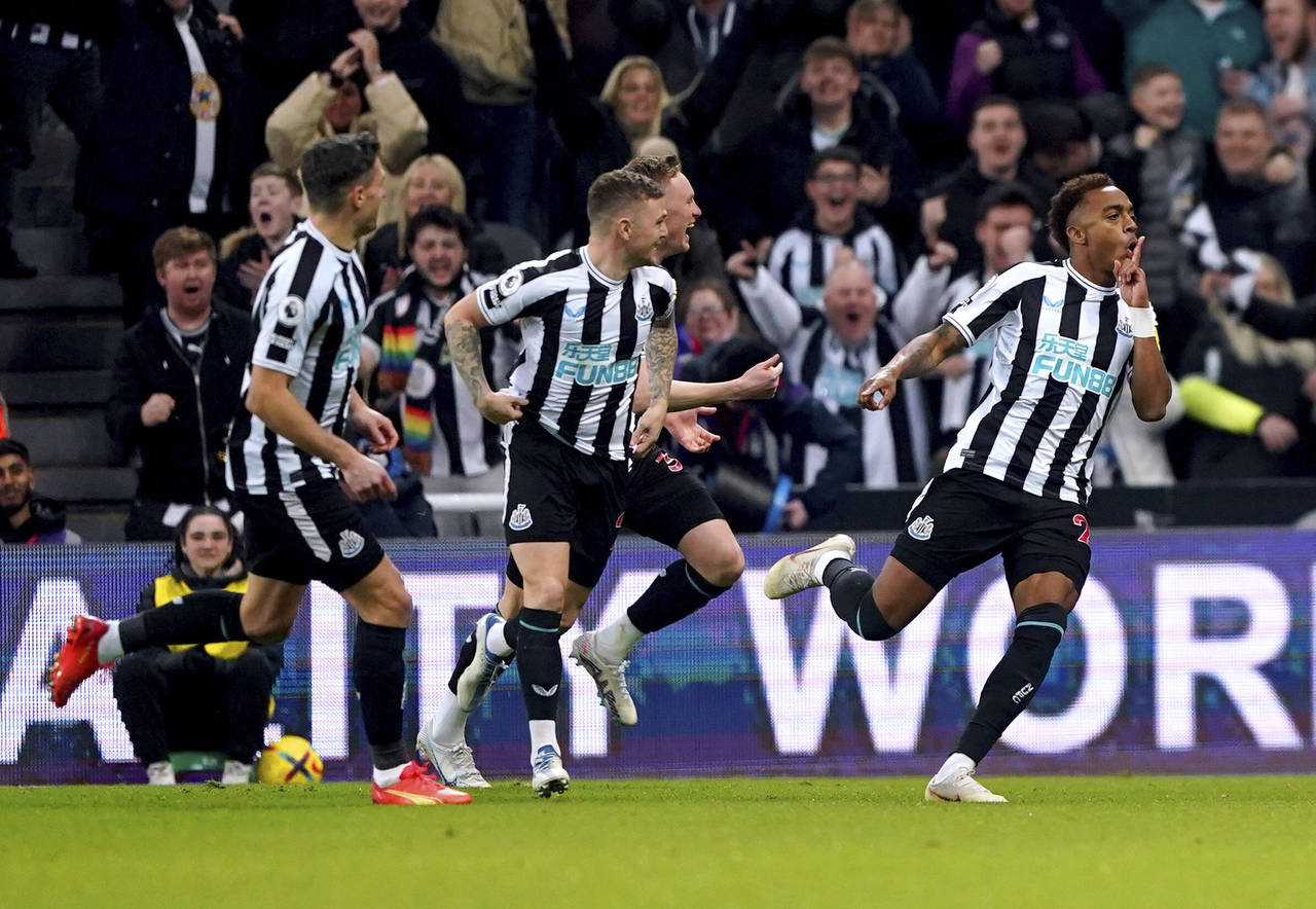 Newcastle United's Joe Willock, right, celebrates scoring a goal before it is later ruled out, duri...