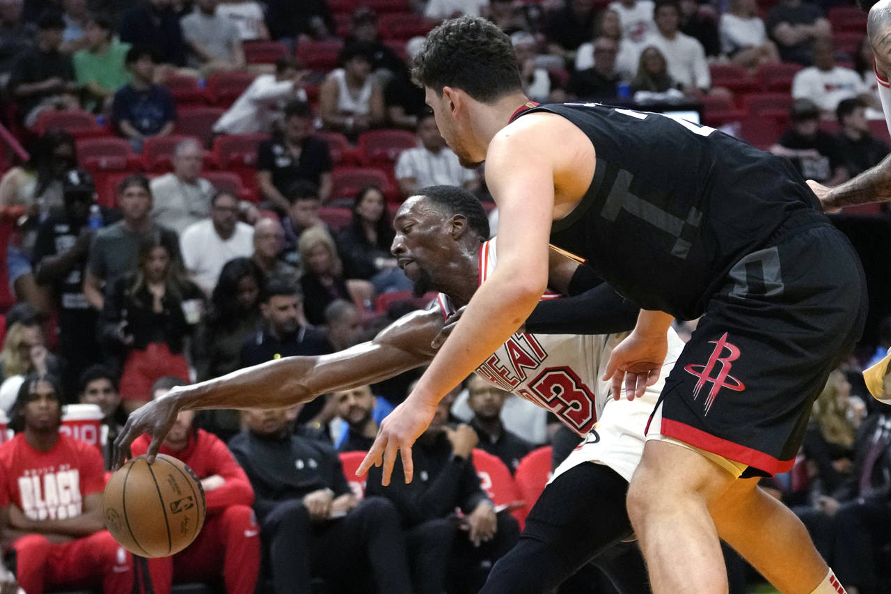 Miami Heat center Bam Adebayo (13) steals the ball from Houston Rockets center Alperen Sengun durin...