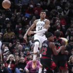 Giannis sets assists mark, hurts wrist; Bucks beat Bulls