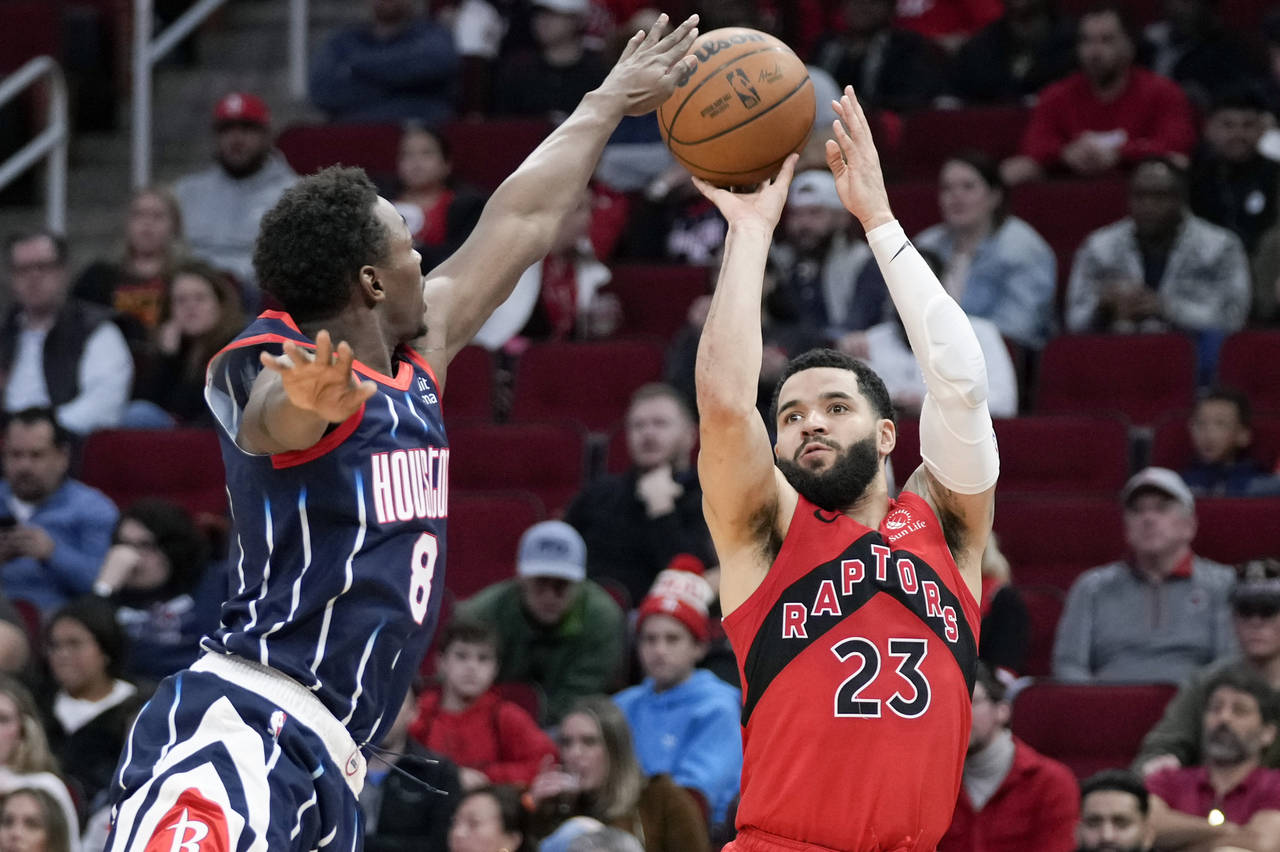 Toronto Raptors guard Fred VanVleet (23) shoots a three point basket as Houston Rockets forward Jae...