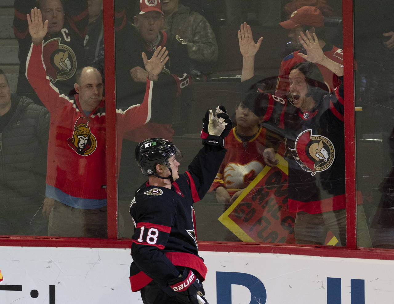 Fans react as Ottawa Senators left wing Tim Stutzle (18) celebrates after his winning goal in overt...