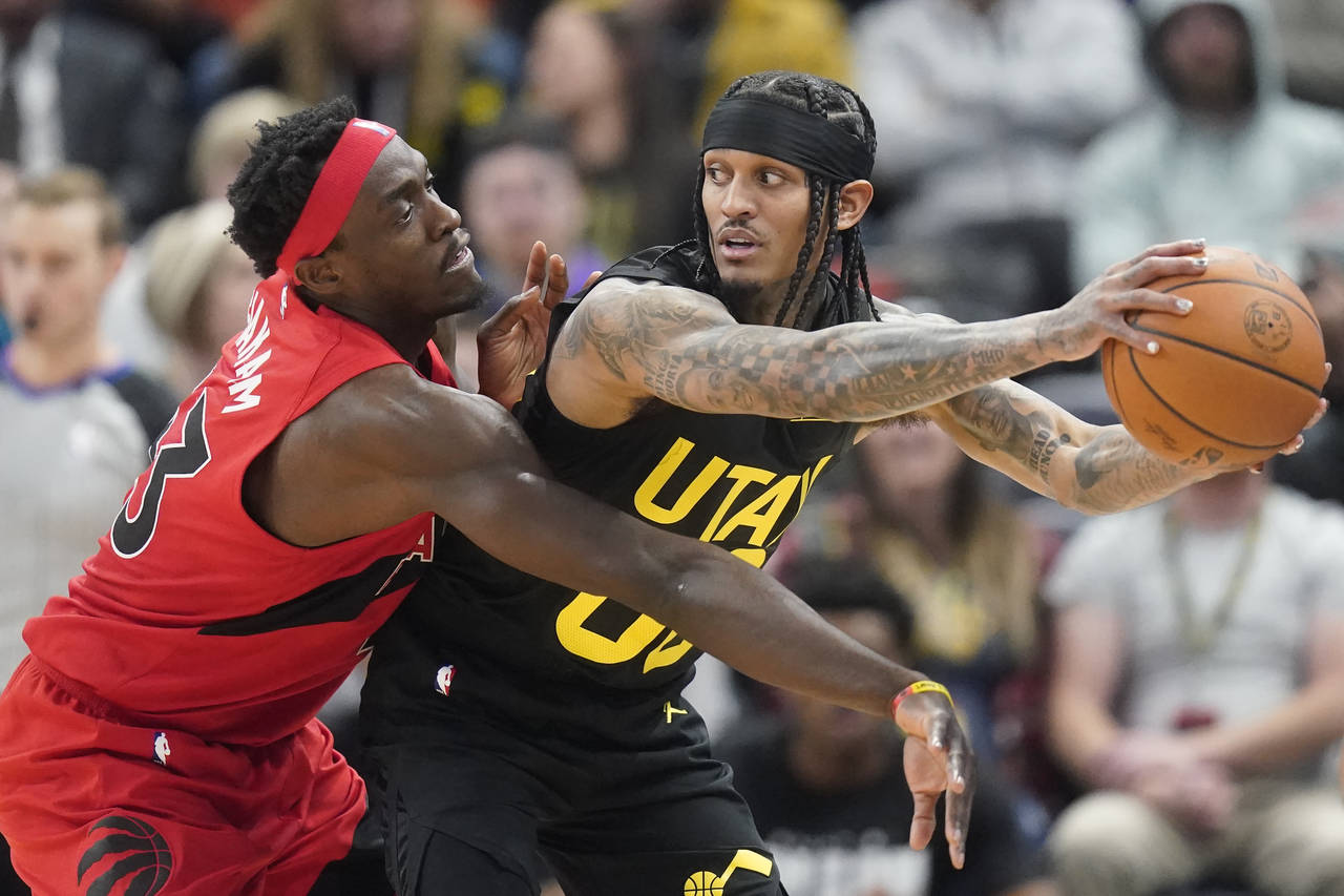 Toronto Raptors forward Pascal Siakam, left, guards Utah Jazz guard Jordan Clarkson, right, during ...
