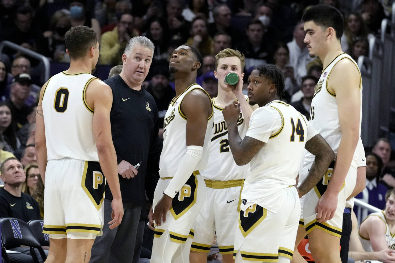 Purdue head coach Matt Painter, second from left, reacts as he talks with his team during the secon...