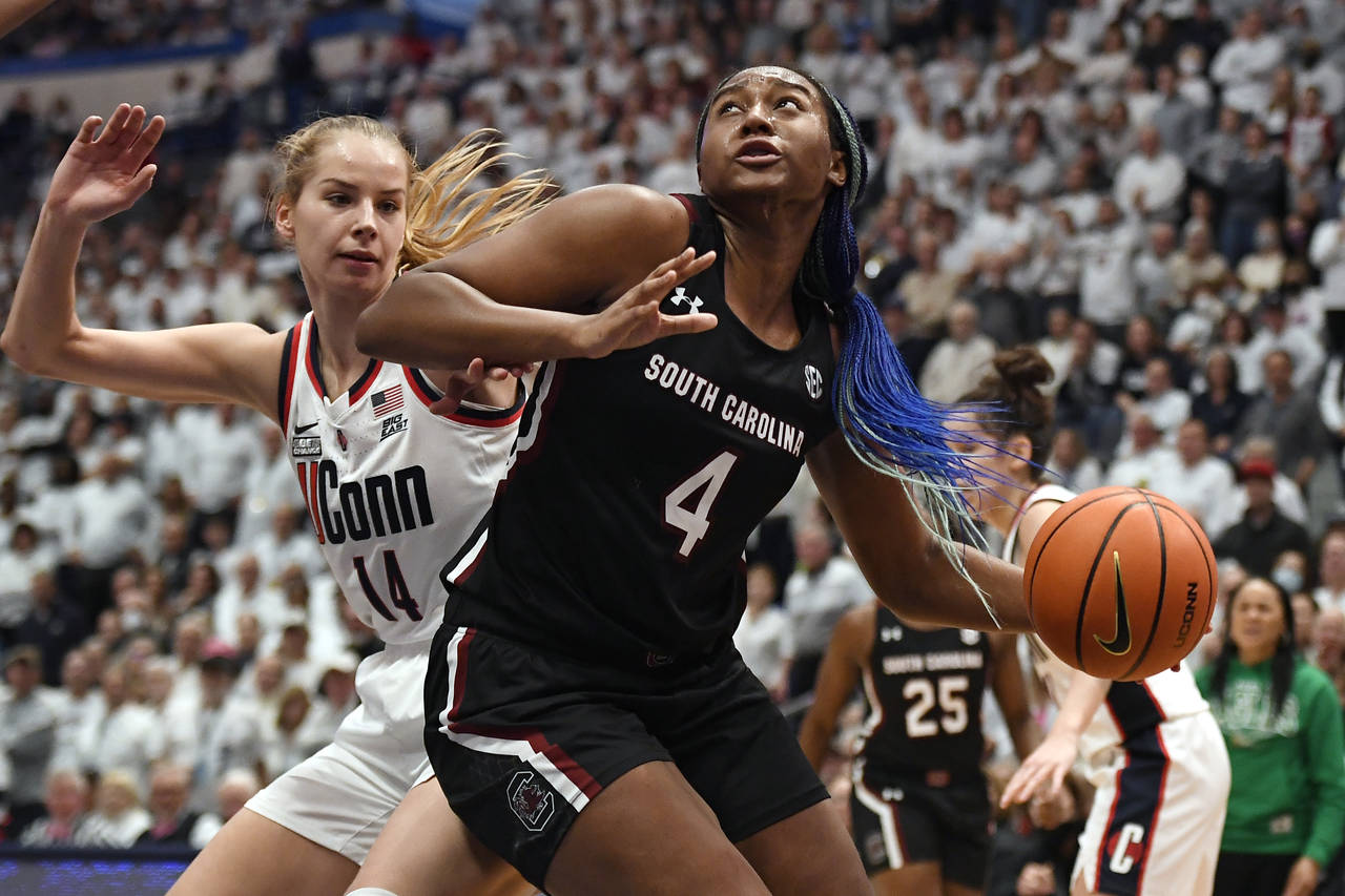 South Carolina's Aliyah Boston (4) drives to the basket as UConn's Dorka Juhasz (14) defends in the...