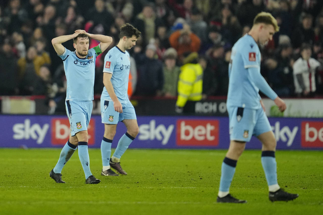 Wrexham players look dejected after Sheffield's Billy Sharp scored his side's second goalduring the...