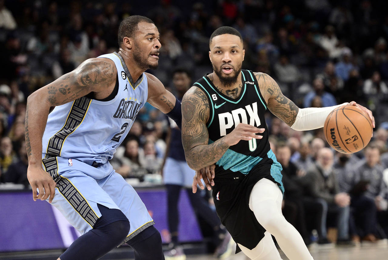 Portland Trail Blazers guard Damian Lillard (0) handles the ball against Memphis Grizzlies forward ...