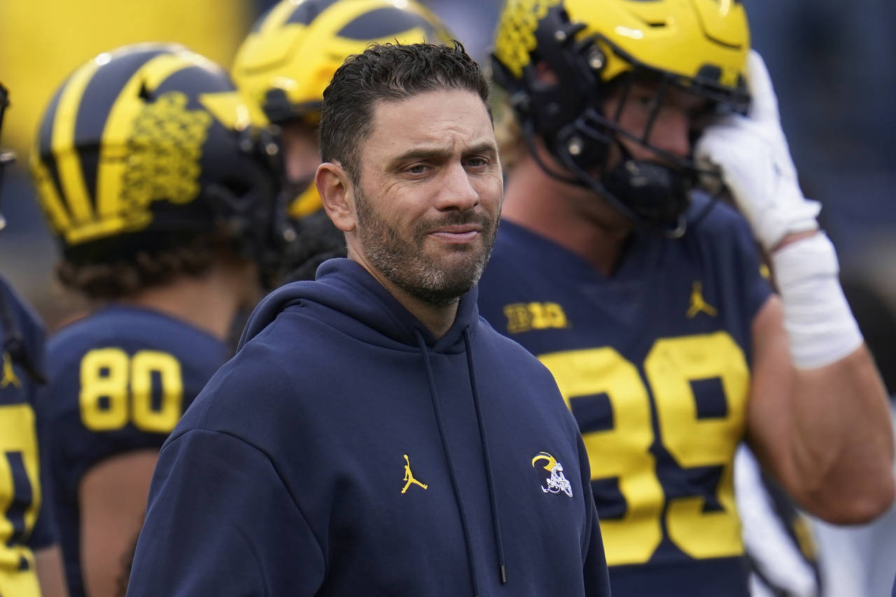 FILE - Michigan co-offensive coordinator and quarterbacks coach Matt Weiss waits for the team's NCA...