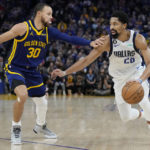 Curry injures left leg leading Warriors over Mavs 119-113