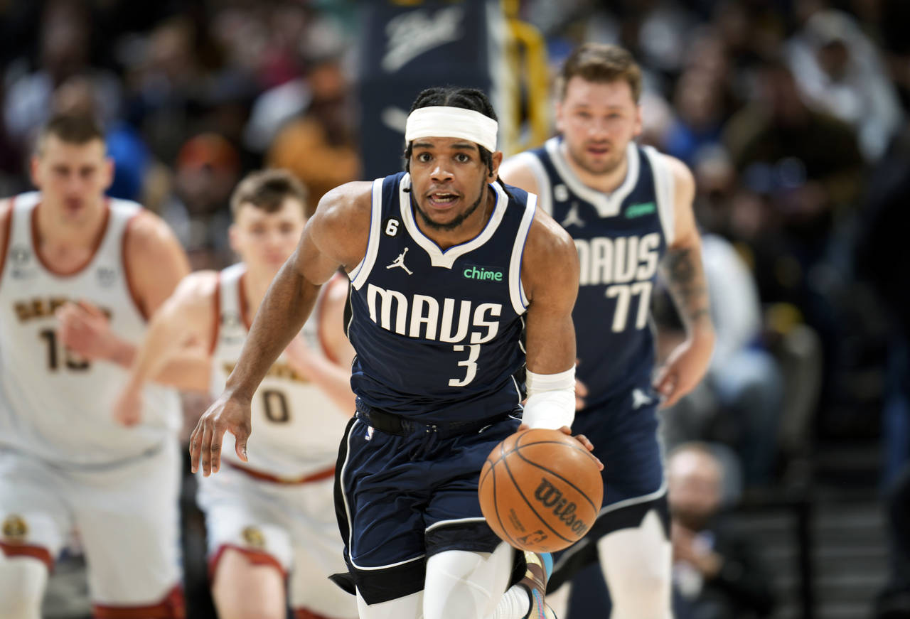 Dallas Mavericks guard Jaden Hardy picks up a loose ball in the first half of an NBA basketball gam...