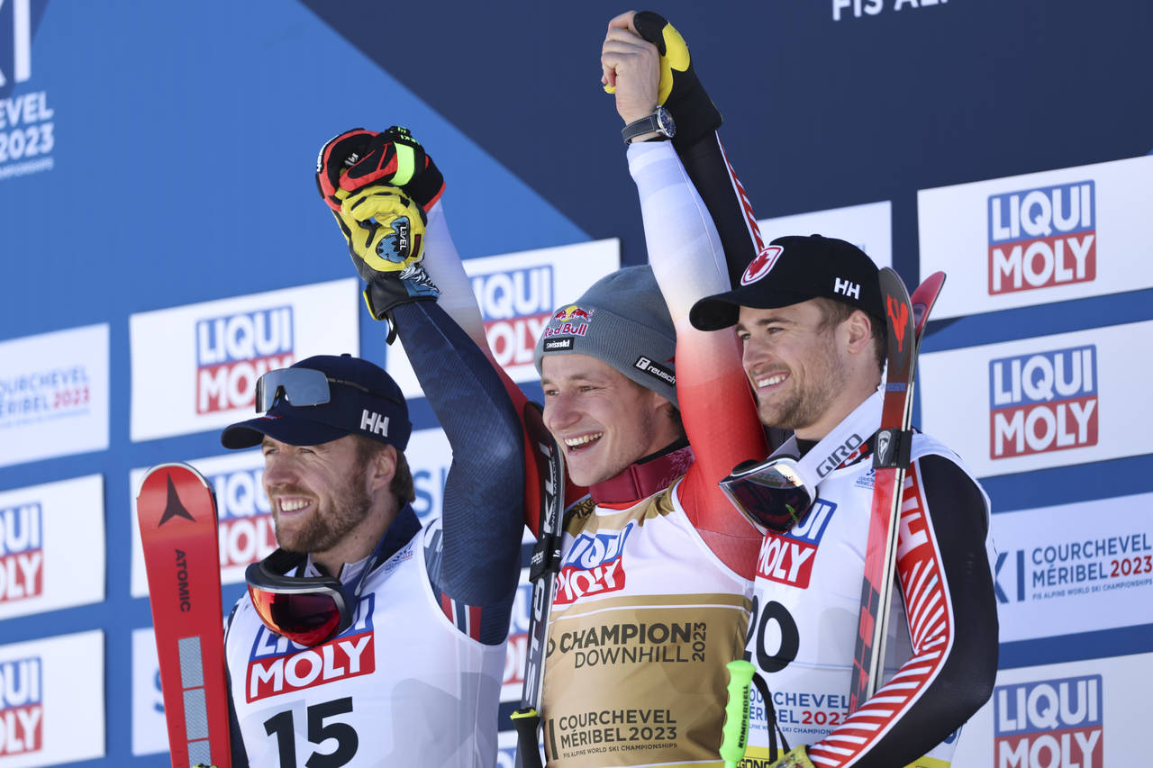Switzerland's Marco Odermatt, center, winner of the alpine ski, men's World Championship downhill, ...