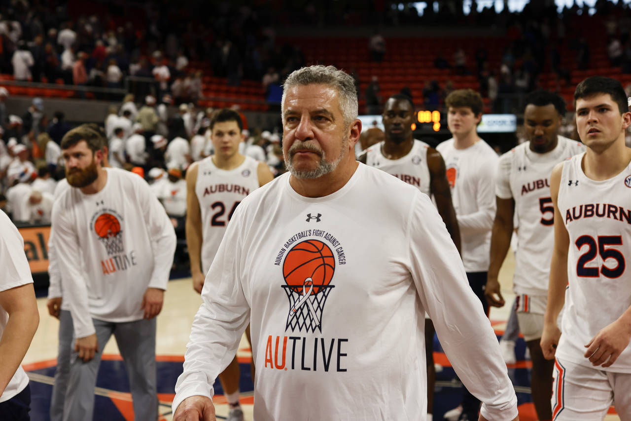 Auburn head coach Bruce Pearl walks off the court after Auburn lost to Alabama in an NCAA college b...