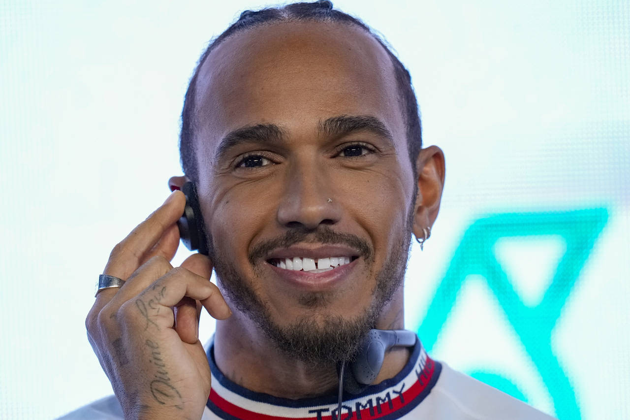 FILE - Mercedes driver Lewis Hamilton of Britain listens to a question during a press conferencein ...