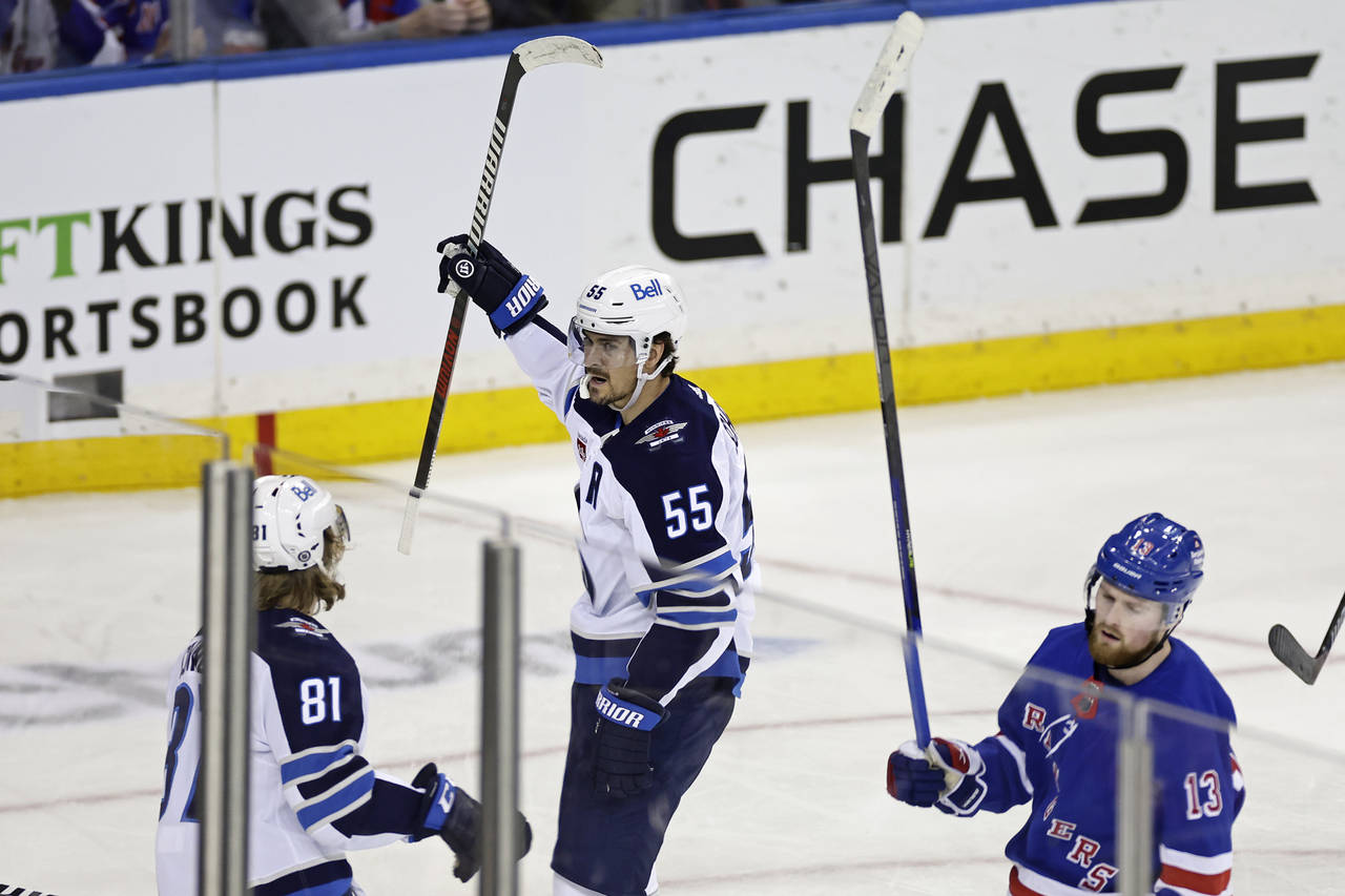 Winnipeg Jets center Mark Scheifele (55) reacts towards Kyle Connor (81) after scoring a goal in fr...