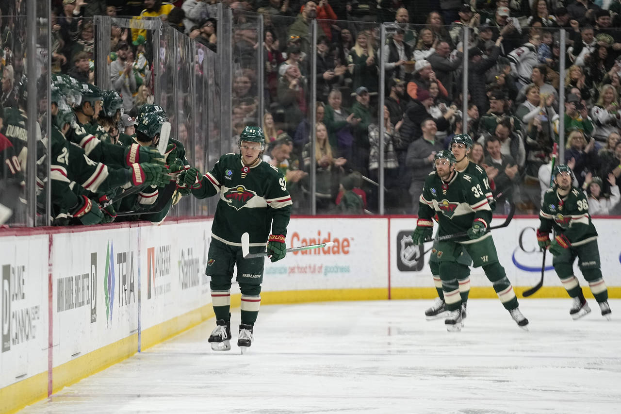 Minnesota Wild left wing Kirill Kaprizov, left, celebrates with teammates after scoring during the ...