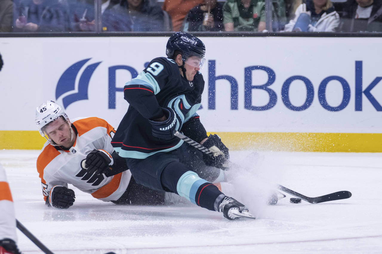 Seattle Kraken forward Ryan Donato, right, and Philadelphia Flyers defenseman Cam York collide duri...