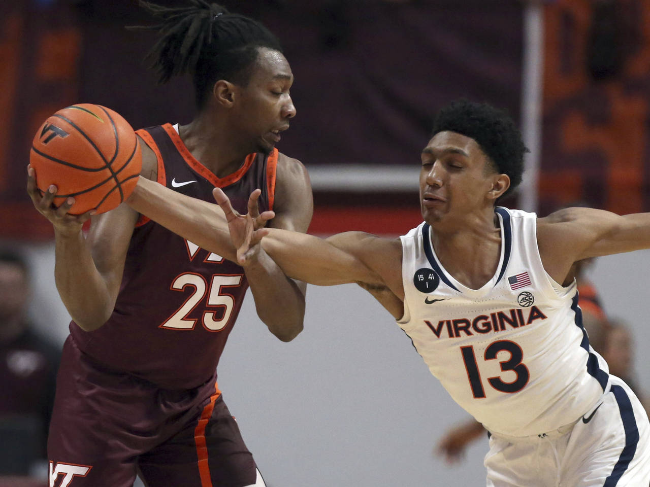 Virginia Tech's Justyn Mutts (25) has the ball tipped from him by Virginia's Ryan Dunn (13) in the ...