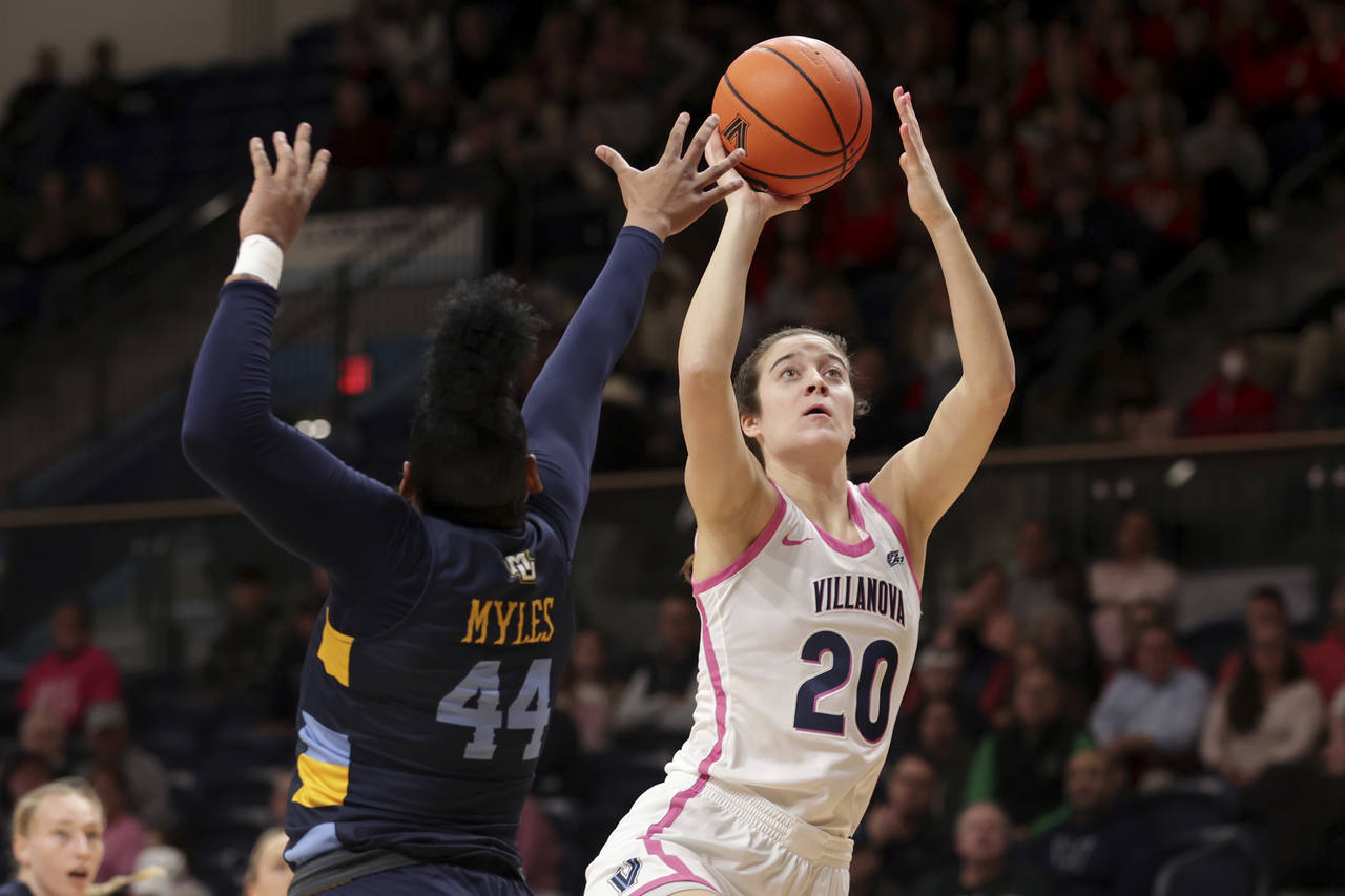 FILE - Villanova's Maddy Siegrist (20) shoots over Marquette's Kennedi Myles of Marquette during th...