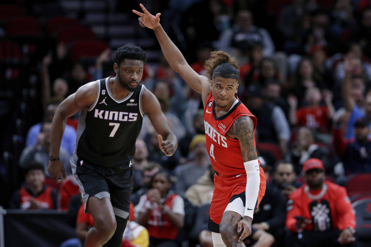 Houston Rockets guard Jalen Green (4) signals after making a 3-point shot, next to Sacramento Kings...