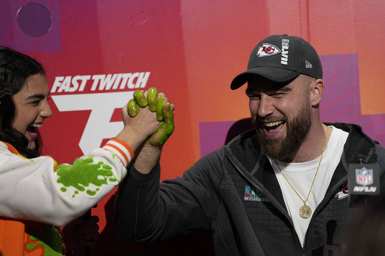 Kansas City Chiefs tight end Travis Kelce speaks with a youngster during the NFL football Super Bow...