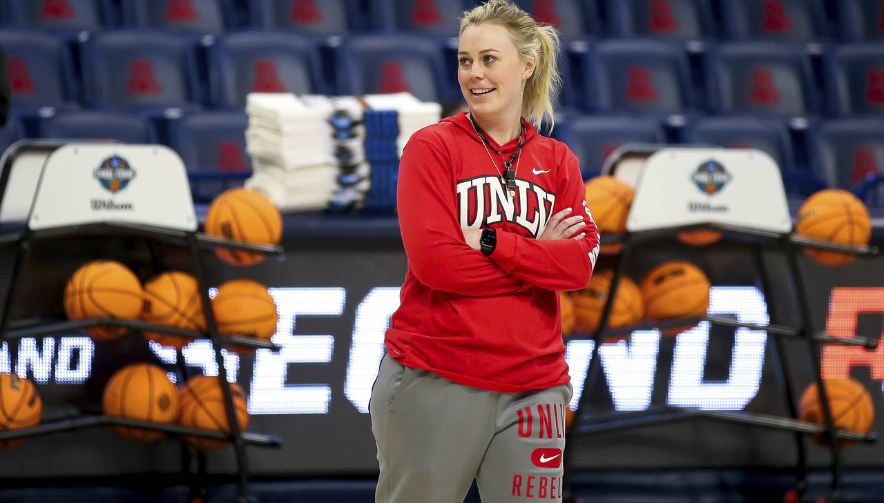 UNLV coach Lindy La Rocque smiles while watching the team shoot layups during practice for the NCAA...