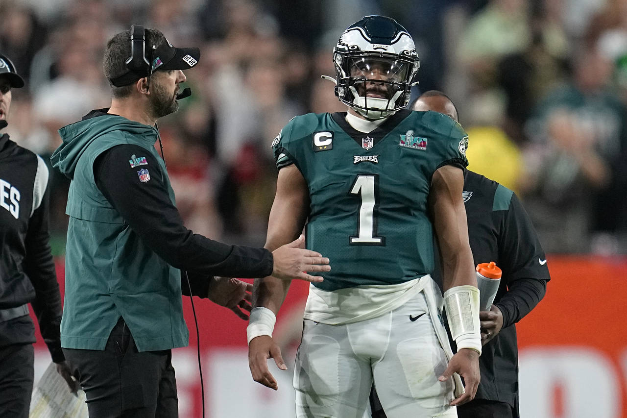 Philadelphia Eagles head coach Nick Sirianni, left, talks with quarterback Jalen Hurts (1) during t...