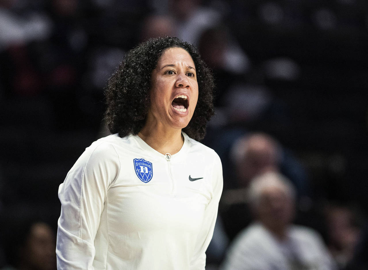 Duke coach Kara Lawson directs the team during the first half of an NCAA college basketball game ag...