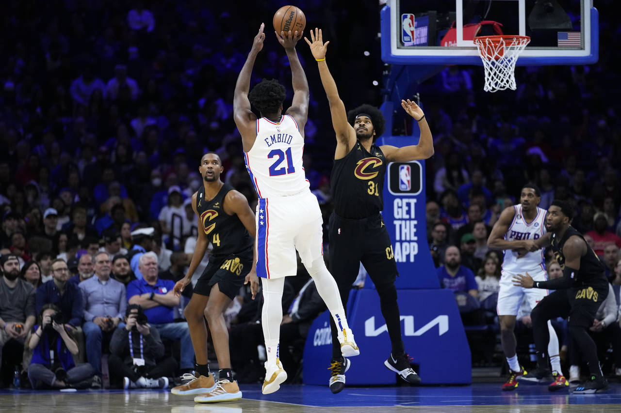 Philadelphia 76ers' Joel Embiid (21) goes up for a shot against Cleveland Cavaliers' Jarrett Allen ...