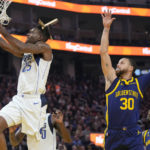 Curry injures left leg leading Warriors over Mavs 119-113
