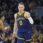 Curry injures left leg leading Warriors over Mavs 119-113