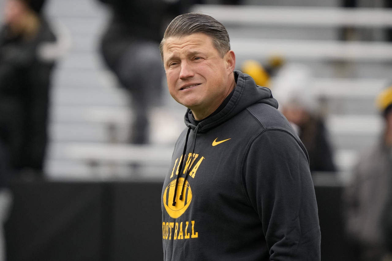 FILE - Iowa offensive coordinator Brian Ferentz stands on the field before an NCAA college football...