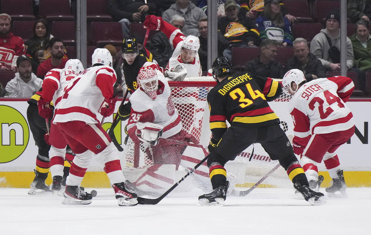 Detroit Red Wings goalie Ville Husso (35) pulls the net down behind him as Vancouver Canucks' Phill...