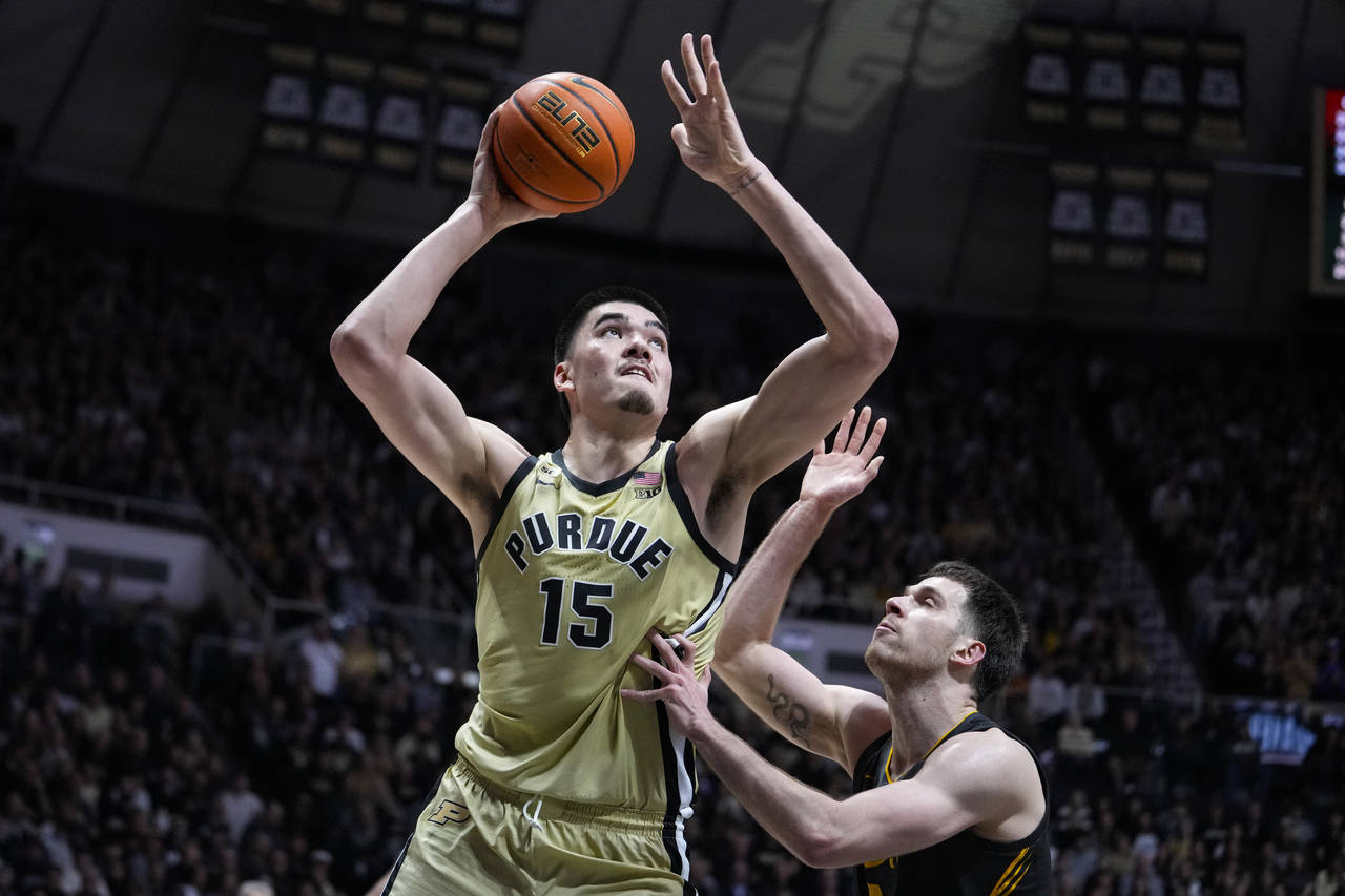 Purdue center Zach Edey (15) shoots over Iowa forward Filip Rebraca (0) during the second half of a...