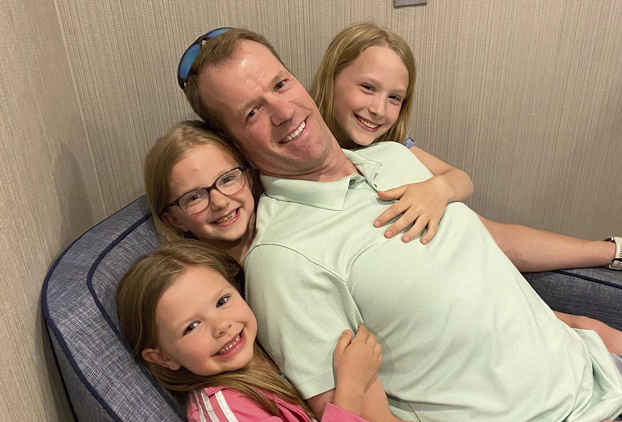 In this undated photo provided by Michael Walton, his brother Scott Walton poses with his daughters...