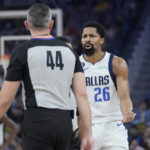 Curry injures left leg leading Warriors over Mavs 119-113
