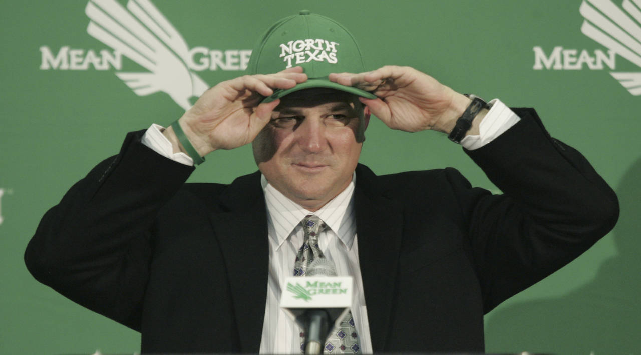 FILE - North Texas football coach Todd Dodge, left, speaks to the media in Denton, Texas, Tuesday, ...