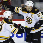 McAvoy scores in OT, Bruins beat Flames as win streak hits 8