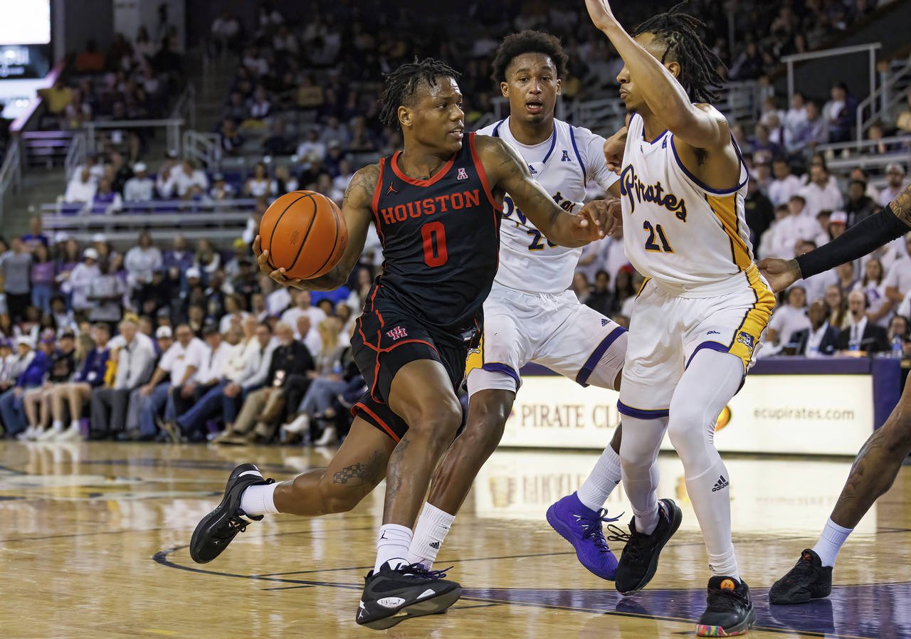 Houston's Marcus Sasser (0) drives against East Carolina's Jaden Walker (21) during the second half...