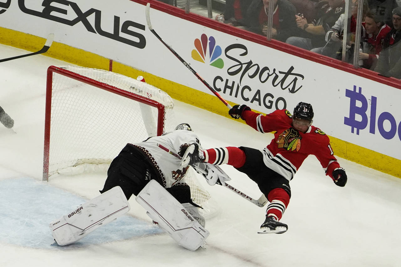 Chicago Blackhawks center Max Domi (13) collides with Arizona Coyotes goaltender Connor Ingram, lef...
