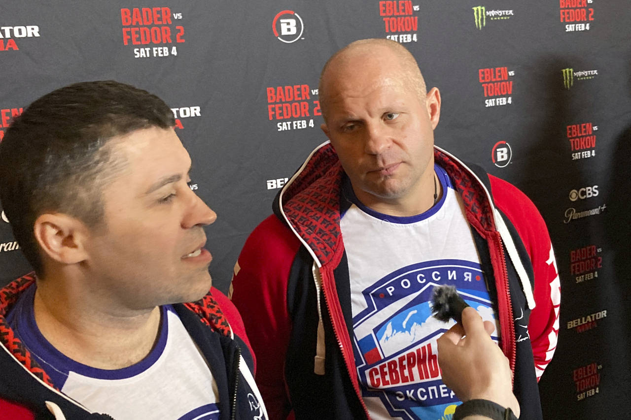 Fedor Emelianenko, rights, listens to interpreter Georgiy Litvinov during an interview in Los Angel...