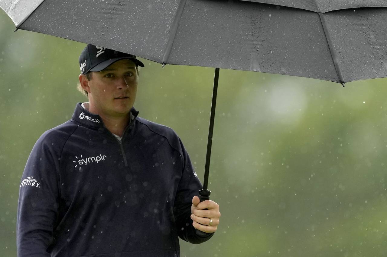 Sepp Straka of Austria walks with umbrella on the 3rd hole during the his first round on Day Two of...