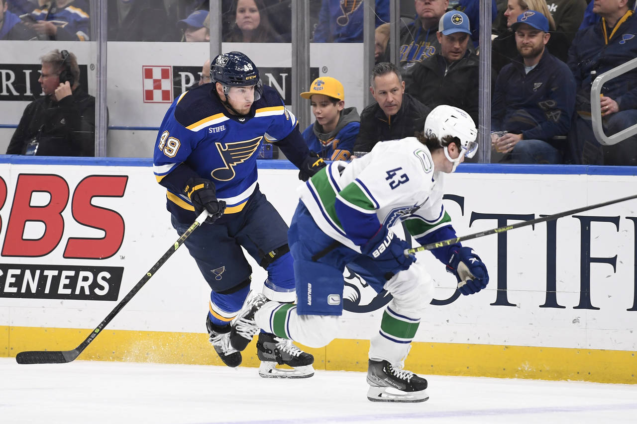 St. Louis Blues center Ivan Barbashev (49) skates against Vancouver Canucks defenseman Quinn Hughes...