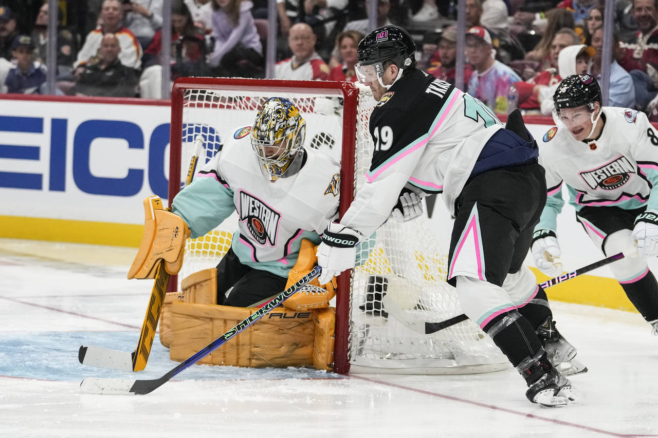 Atlantic Division's Matthew Tkachuk, of the Florida Panthers (19) works against Central Division's ...