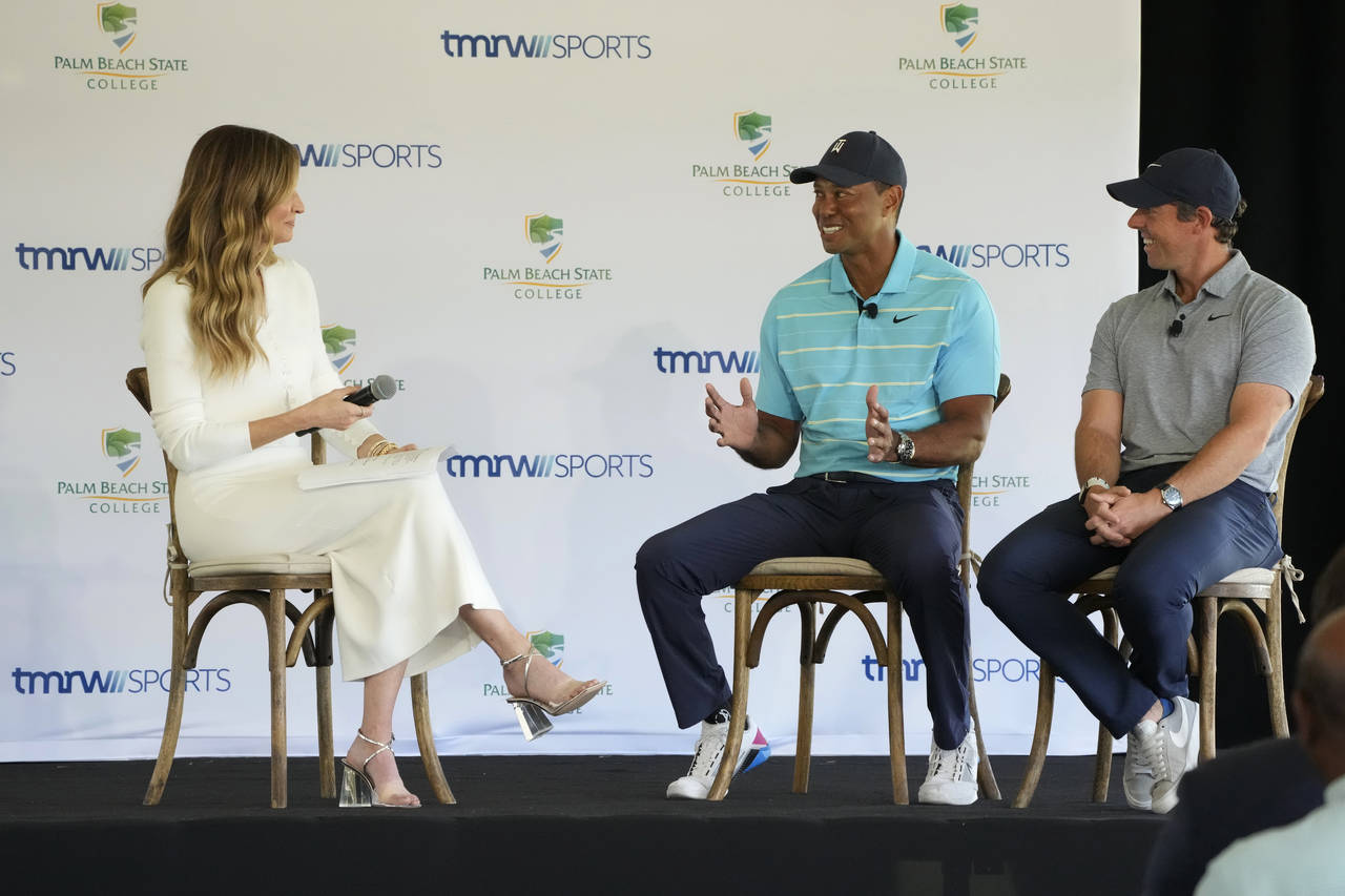 Golfers Tiger Woods, center, and Rory McIlroy, right, talk to host Erin Andrews as they discuss the...