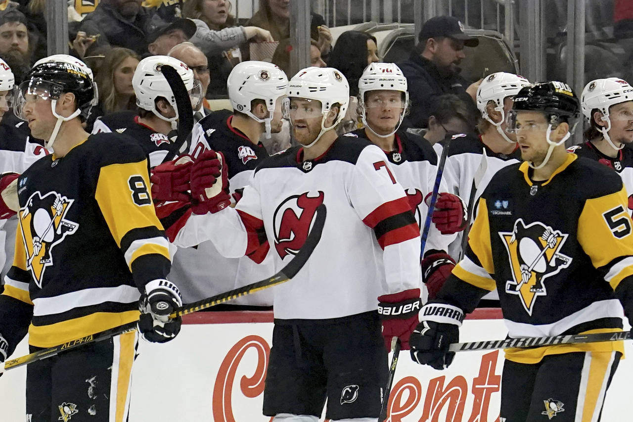 New Jersey Devils teammates congratulate defenseman Dougie Hamilton (7) after he scored against the...