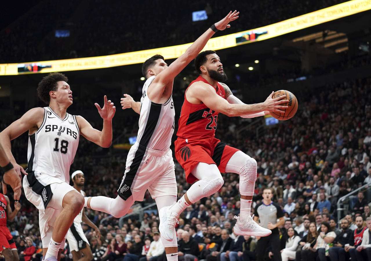 Toronto Raptors guard Fred VanVleet (23) shoots against San Antonio Spurs forward Isaiah Roby (18) ...
