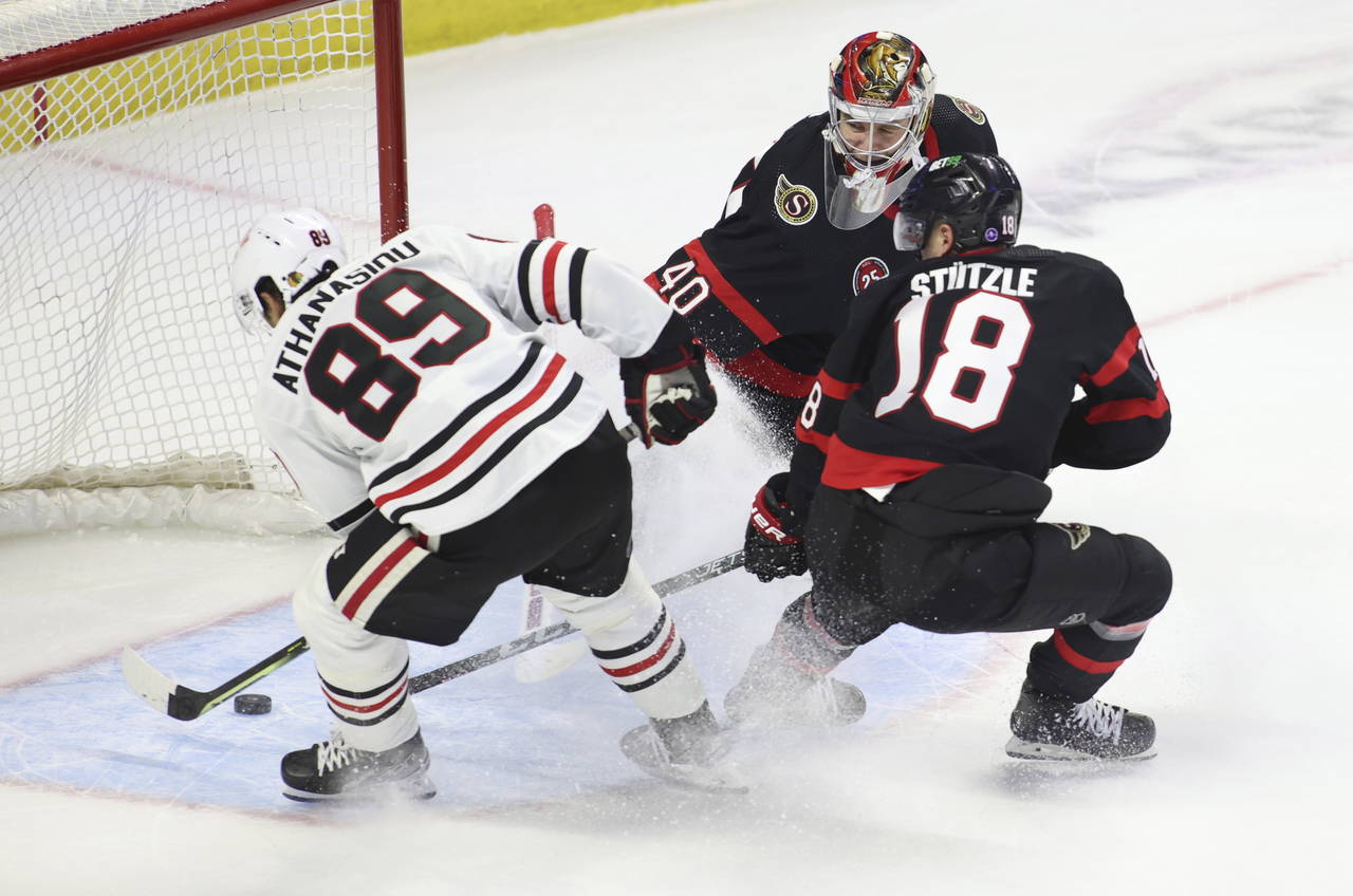 Chicago Blackhawks Andreas Athanasiou (89) scores against Ottawa Senators goaltender Mads Sogaard (...