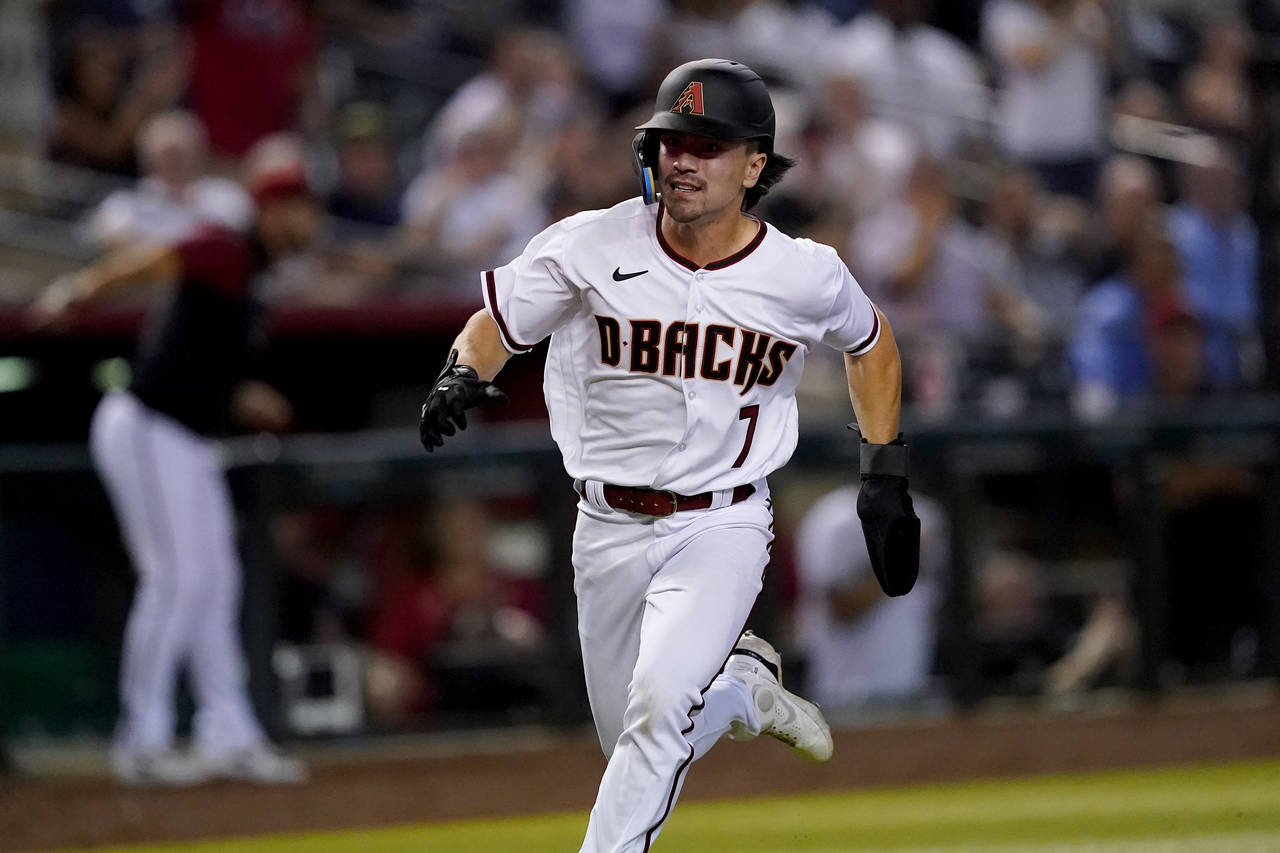 FILE - Arizona Diamondbacks' Corbin Carroll scores on a double by Carson Kelly during the fourth in...