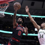 Giannis sets assists mark, hurts wrist; Bucks beat Bulls